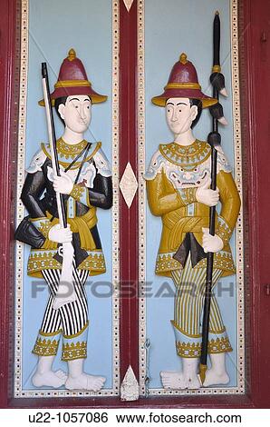 Bangkok (Thailand): ancient guards on a door's relief at the Royal Palace View Large Photo Image Stock Photograph - Bangkok (Thailand): ancient guards on a door's relief at the Royal Palace. Fotosearch