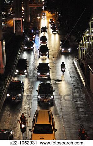 Stock Image - Bangkok (Thailand): night traffic along Ploenchit Road. Fotosearch