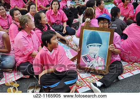 Bangkok (Thailand): people wearing pink T-shirts, symbol of the Thai monarchy, in the Royal Plaza during the king Bhumibol Adulyadej birthday's public commemoration (December 5th) View Large Photo Image Stock Photography - Bangkok (Thailand): people wearing pink T-shirts, symbol of the Thai monarchy, in the Royal Plaza during the king Bhumibol Adulyadej birthday's public commemoration (December 5th). Fotosearch