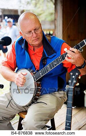 Stock Photo - Banjo Player Performs with Pleasant Family Country Band at Cracker Country Florida living history museum located on the Florida State Fairgrounds Tampa. Fotosearch