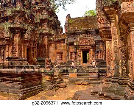 Stock Image - Banteay Srei temple, cntral courtyard with monkey and yaksha guardian figures. Siem Reap, Cambodia. Dedicated o Hindu god Shiva.. Fotosearch