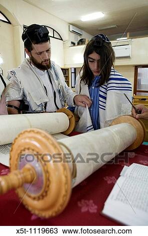 Stock Image - Bar Mitzvah ceremony in a synagogue reading the Torah. Fotosearch