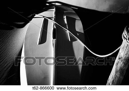 Stock Image - Barca blanca tumbada en la arena Playa en invierno Costa Dorada, Tarragona, Spain. Fotosearch