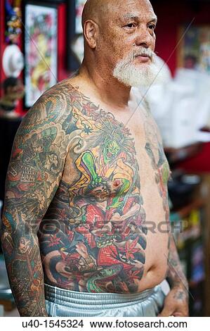 Bare chested man with tattoos View Large Photo Image Picture - Bare chested man with tattoos. Fotosearch