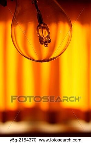 bare light bulb and orange curtains in dark room View Large Photo Image Stock Image - bare light bulb and orange curtains in dark room. Fotosearch