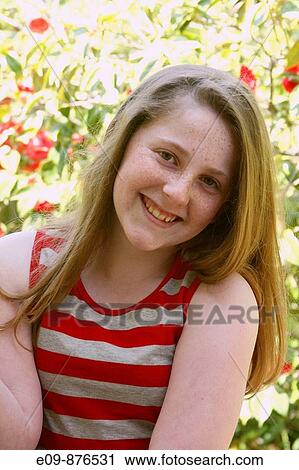 barely-teenage girl, long gold-brown hair, freckles, smiling at camera, wearing striped tank top, sunlit foliage behind View Large Photo Image Stock Image - barely-teenage girl, long gold-brown hair, freckles, smiling at camera, wearing striped tank top, sunlit foliage behind. Fotosearch