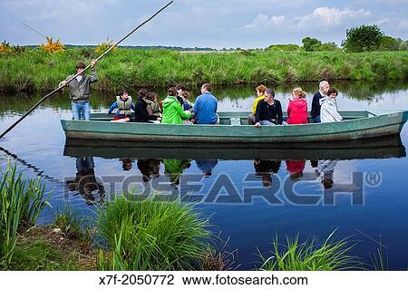 Barge with tourists, near Port of Breca, Natural regional park of La Briere, Loire Atlantique, Pays de Loire, France. View Large Photo Image Stock Image - Barge with tourists, near Port of Breca, Natural regional park of La Briere, Loire Atlantique, Pays de Loire, France.. Fotosearch