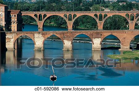 Barge with tourists on Tarn river and Pont Vieux bridge (11th century), Albi. Tarn, France View Large Photo Image Stock Photograph - Barge with tourists on Tarn river and Pont Vieux bridge (11th century), Albi. Tarn, France. Fotosearch