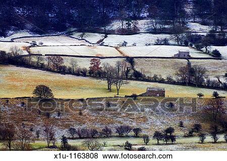 Stock Photo - Barns on the slopes of Pen Hill Wensleydale Yorkshire Dales England. Fotosearch