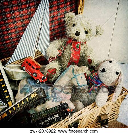 Stock Image - Basket full of childrens toys, textured image.. Fotosearch
