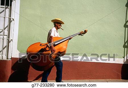 Bass Player carrying his instrument in a Street of Trinidad de Cuba. Cuba View Large Photo Image Stock Image - Bass Player carrying his instrument in a Street of Trinidad de Cuba. Cuba. Fotosearch