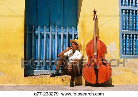 Bass player sat in a doorway with his Double bass. Trinidad de Cuba. Cuba View Large Photo Image Stock Photo - Bass player sat in a doorway with his Double bass. Trinidad de Cuba. Cuba. Fotosearch