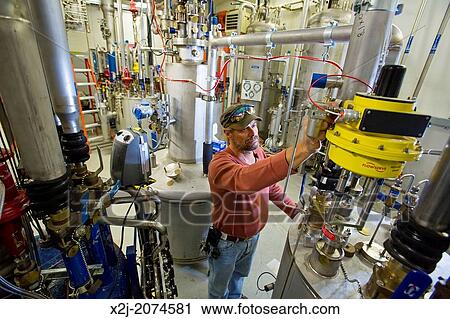 Stock Image - Batavia, Illinois - Adjusting a laser at the New Muon Lab at the Fermi National Accelerator Laboratory.. Fotosearch