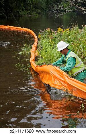 Battle Creek, Michigan - A worker places containment boom on the Kalamazoo River to contain an oil spill More than 800, 000 gallons of oil spilled from an Enbridge Energy Partners pipeline View Large Photo Image Stock Image - Battle Creek, Michigan - A worker places containment boom on the Kalamazoo River to contain an oil spill More than 800, 000 gallons of oil spilled from an Enbridge Energy Partners pipeline. Fotosearch