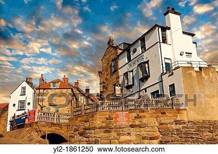 Stock Image - Bay Hotel & fishermans houses of the historic fishing village of Robin Hood's Bay, Near Whitby, North Yorkshire, England. Fotosearch