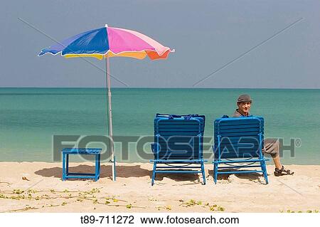 Beach chair, umbrela and traveler View Large Photo Image Stock Image - Beach chair, umbrela and traveler. Fotosearch