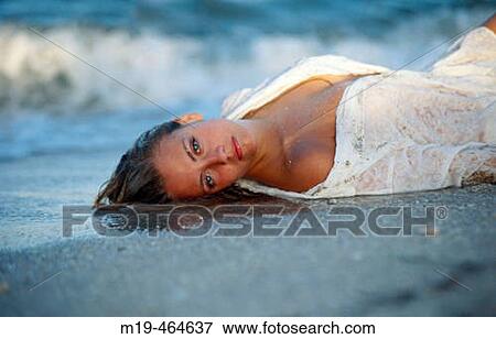 beach girl lying on the waters edge View Large Photo Image Stock Photo - beach girl lying on the waters edge. Fotosearch