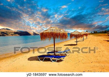 Stock Photo - Beach & sunbeds on Agrostoli Bay near Lixouri, Kefalonia, Ionian Islands, Greece. Fotosearch