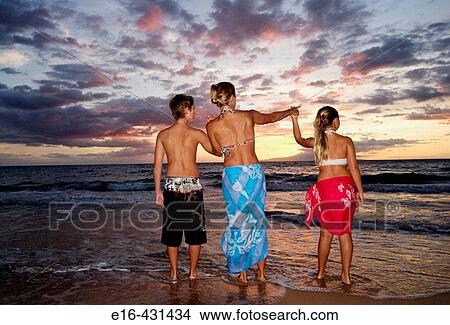 Beach sunset with mother and kids View Large Photo Image Picture - Beach sunset with mother and kids. Fotosearch