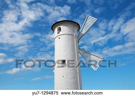 Beacon? Windmill? on stone pier next to port entry in Swinoujscie at Baltic Sea, Poland View Large Photo Image Stock Photography - Beacon? Windmill? on stone pier next to port entry in Swinoujscie at Baltic Sea, Poland. Fotosearch