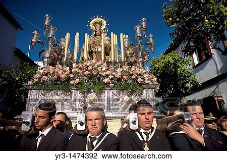 Stock Image - Bearers of religious images carry a Virgin of Carmen sculpture during an Easter procession in the town of Prado del Rey in southern Spain's Cadiz Sierra region in Andalucia, April 24, 2011. Fotosearch