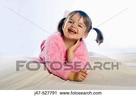 beautiful 2 year old girl with blonde pigtails, lying on her tummy, smiling off camera, in the studio View Large Photo Image Stock Image - beautiful 2 year old girl with blonde pigtails, lying on her tummy, smiling off camera, in the studio. Fotosearch