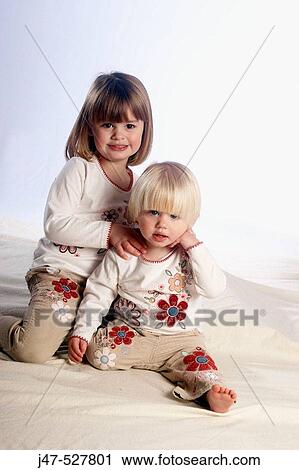 beautiful 3 year old girl with blonde hair, smiling into camera, in the studio, with her 2 year old baby sister, smiling View Large Photo Image Stock Image - beautiful 3 year old girl with blonde hair, smiling into camera, in the studio, with her 2 year old baby sister, smiling. Fotosearch