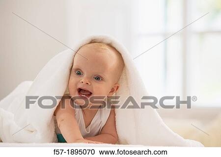 Beautiful baby boy lying with a white towel covering his head View Large Photo Image Stock Image - Beautiful baby boy lying with a white towel covering his head. Fotosearch