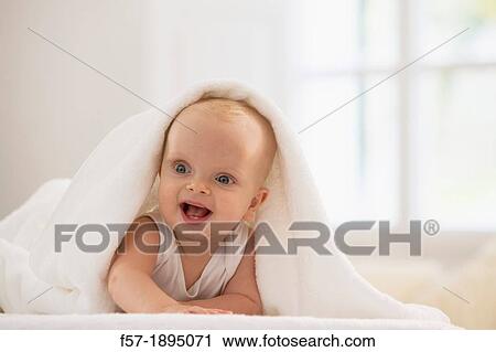 Beautiful baby boy lying with a white towel covering his head View Large Photo Image Stock Image - Beautiful baby boy lying with a white towel covering his head. Fotosearch
