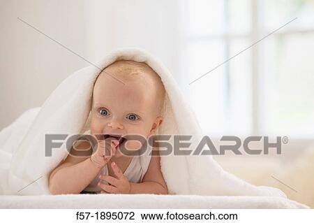 Beautiful baby boy lying with a white towel covering his head View Large Photo Image Stock Image - Beautiful baby boy lying with a white towel covering his head. Fotosearch