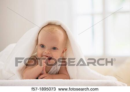 Beautiful baby boy lying with a white towel covering his head View Large Photo Image Stock Image - Beautiful baby boy lying with a white towel covering his head. Fotosearch