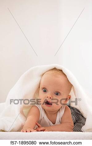 Beautiful baby boy lying with a white towel covering his head View Large Photo Image Stock Image - Beautiful baby boy lying with a white towel covering his head. Fotosearch