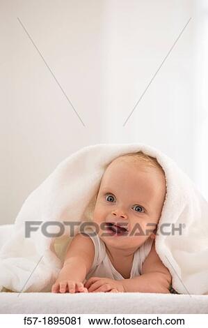 Beautiful baby boy lying with a white towel covering his head View Large Photo Image Stock Image - Beautiful baby boy lying with a white towel covering his head. Fotosearch