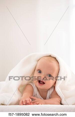 Beautiful baby boy lying with a white towel covering his head View Large Photo Image Stock Image - Beautiful baby boy lying with a white towel covering his head. Fotosearch