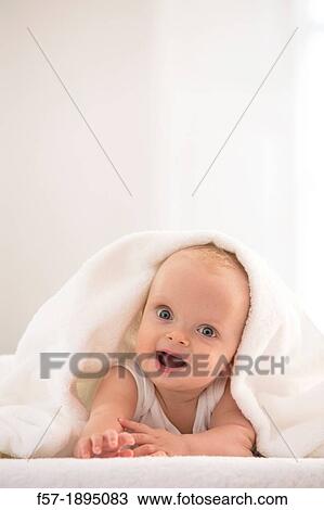 Beautiful baby boy lying with a white towel covering his head View Large Photo Image Stock Image - Beautiful baby boy lying with a white towel covering his head. Fotosearch