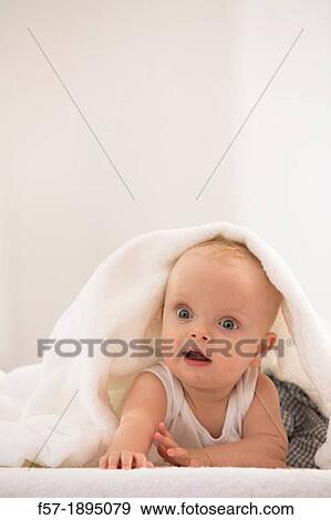 Beautiful baby boy lying with a white towel covering his head View Large Photo Image Stock Photo - Beautiful baby boy lying with a white towel covering his head. Fotosearch