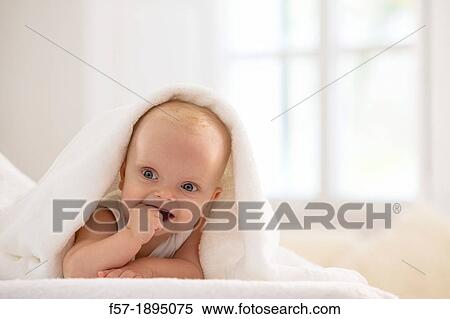 Beautiful baby boy lying with a white towel covering his head View Large Photo Image Stock Photography - Beautiful baby boy lying with a white towel covering his head. Fotosearch