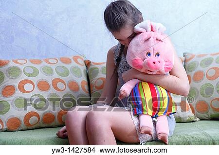 Beautiful Blond girl with her Plush Pig View Large Photo Image Picture - Beautiful Blond girl with her Plush Pig. Fotosearch