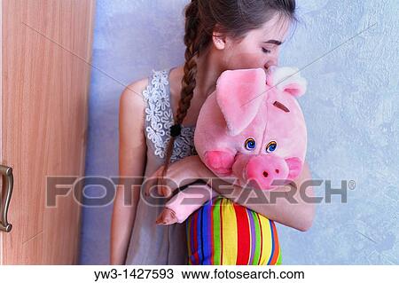 Beautiful Blond girl with her Plush Pig View Large Photo Image Stock Image - Beautiful Blond girl with her Plush Pig. Fotosearch