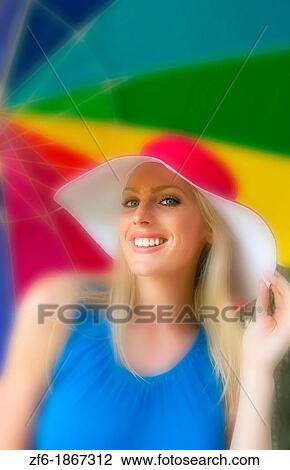 Beautiful blonde attractive woman in red hat and under colorful umbrella outdoors View Large Photo Image Stock Image - Beautiful blonde attractive woman in red hat and under colorful umbrella outdoors. Fotosearch