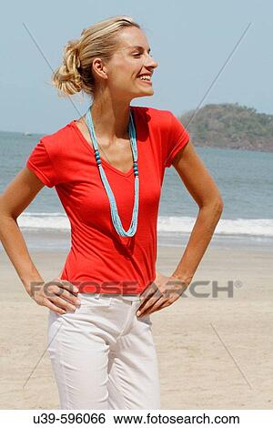 Beautiful blonde woman wearing a red t-shirt and laughing on a beach in India. View Large Photo Image Stock Photograph - Beautiful blonde woman wearing a red t-shirt and laughing on a beach in India.. Fotosearch