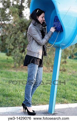 Stock Photograph - beautiful brunette outdoor calling by street phone. Fotosearch