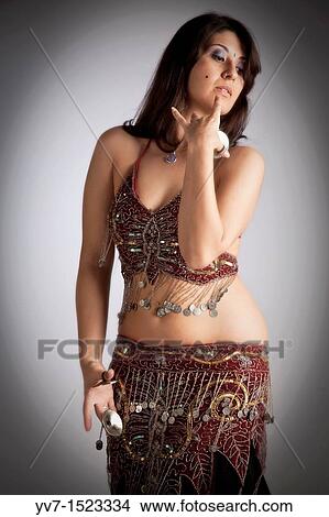 Beautiful brunette practicing belly dancing View Large Photo Image Picture - Beautiful brunette practicing belly dancing. Fotosearch