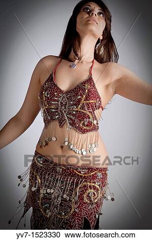 Beautiful brunette practicing belly dancing View Large Photo Image Stock Image - Beautiful brunette practicing belly dancing. Fotosearch