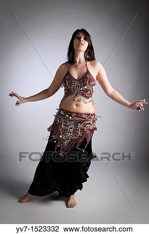 Beautiful brunette practicing belly dancing View Large Photo Image Stock Image - Beautiful brunette practicing belly dancing. Fotosearch