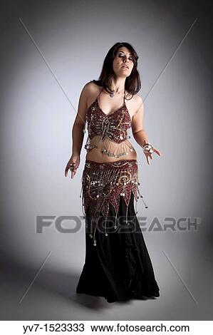 Beautiful brunette practicing belly dancing View Large Photo Image Stock Image - Beautiful brunette practicing belly dancing. Fotosearch