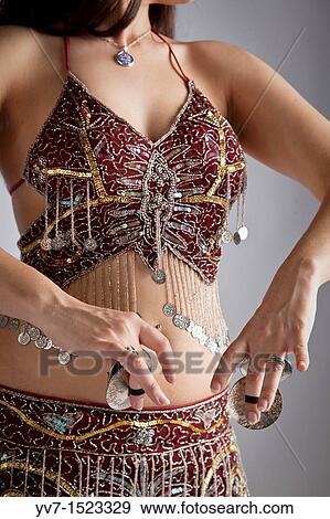 Beautiful brunette practicing belly dancing View Large Photo Image Stock Photo - Beautiful brunette practicing belly dancing. Fotosearch