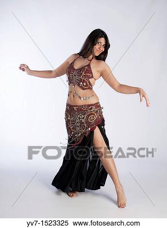Beautiful brunette practicing belly dancing View Large Photo Image Stock Photography - Beautiful brunette practicing belly dancing. Fotosearch