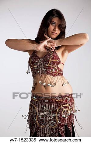 Beautiful brunette practicing belly dancing View Large Photo Image Stock Photography - Beautiful brunette practicing belly dancing. Fotosearch