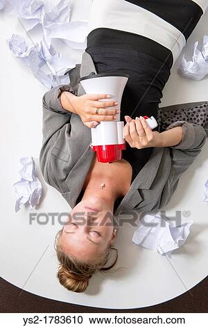 Beautiful businesswoman having a break from too much paperwork She lies exhausted from stress in her workplace View Large Photo Image Stock Image - Beautiful businesswoman having a break from too much paperwork She lies exhausted from stress in her workplace. Fotosearch